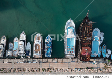 Variety of boats are docking at a pier, creating a colorful and dynamic scene. Ayia Napa, Cyprus 130655037