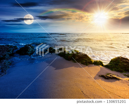 beach with sand. day and night time change concept. summer solstice at the seaside. beautiful seascape with calm waves under sun and moon at twilight. landscape at the sea under sky with fluffy clouds 130655201