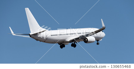 Airplane take off on the blue sky, Aircraft flying on sky background. White passenger jet plane in the blue sky. Low angle view of Airplane flying under blue sky Airplane take off on the blue sky, Aircraft flying on sky background. White passenger jet plane in the blue sky. Low angle view of Airplane flying under blue sky 130655468