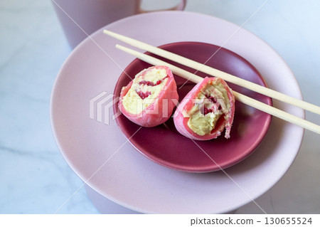 Pink mochi dessert with cream filling and berry. Cut Pink mochi dessert with cream filling and berry. Cut 130655524