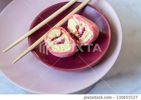 Pink mochi dessert with cream filling and berry. Cut Pink mochi dessert with cream filling and berry. Cut 130655527