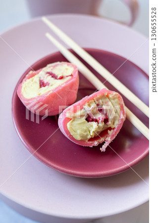 Pink mochi dessert with cream filling and berry. Cut Pink mochi dessert with cream filling and berry. Cut 130655528