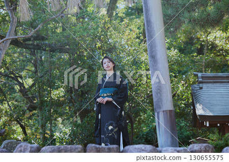 A woman in a kimono posing in front of a torii gate | Japanese garden, Japanese style, tourism image 130655575