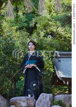 A woman in a kimono posing in front of a torii gate | Japanese garden, Japanese style, tourism image 130655583