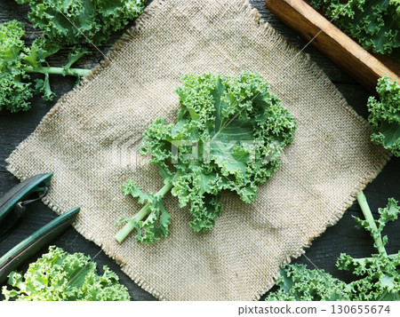 Fresh green curly kale leaves on a wooden table. Healthy vegetarian food 130655674