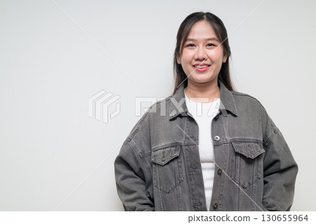 Portrait of young stylish happy Asian woman smiling against white background 130655964