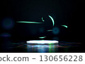 Minimalist white circular stage illuminated by blue light on a dark, reflective surface. Abstract glowing neon green lines and curved shapes float above, creating a futuristic empty scene. 130656228