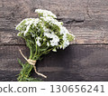 Yarrow flower herbal plants on wooden table. Top view 130656241