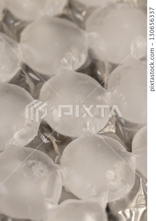 white ice in bags for freezing water, frozen water in special bags for making beautifully shaped ice and using it in drinks and cocktails white ice in bags for freezing water, frozen water in special bags for making beautifully shaped ice and using it in drinks and cocktails 130656337