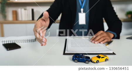 Car Insurance Consultation. Professional agent offering handshake to client. 130656451