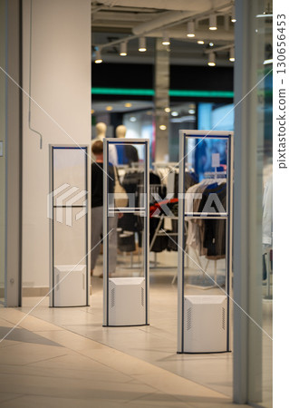 Radio-frequency security gates with integrated metal detector at a clothing store entrance 130656453