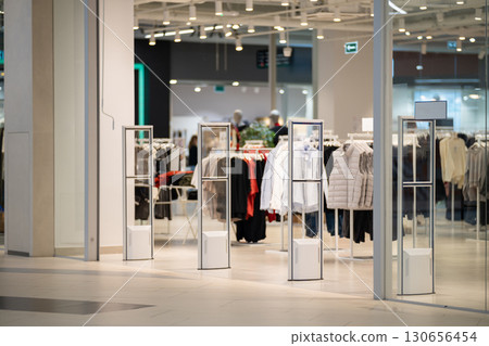 Radio-frequency security gates with integrated metal detector at a clothing store entrance 130656454