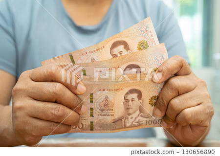 Asian woman counting Thai baht banknote money, investment economy, accounting business and banking. 130656890