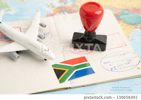 South Africa flag with passport and airplane for travel. 130656891
