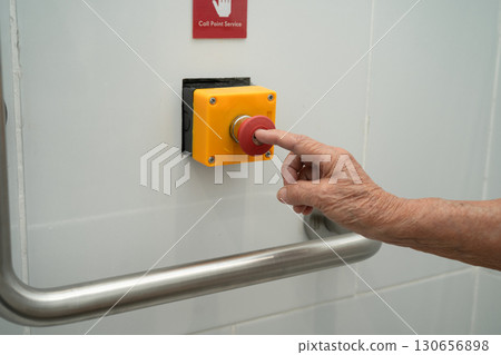 Asian elderly woman press emergency button in toilet. 130656898