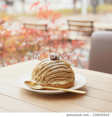 A large Mont Blanc cake and autumn leaves on a cafe table - Autumn Tastes Special Feature - Eye-catching 130656928
