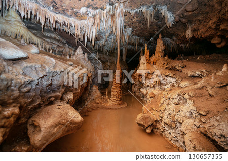 Majestic view of cave interior with stalactites hanging from ceiling Majestic view of cave interior with stalactites hanging from ceiling 130657355