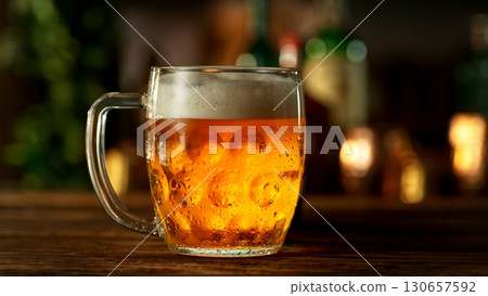 Pouring Beer into Pint Glass in a Pub, Close-up 130657592