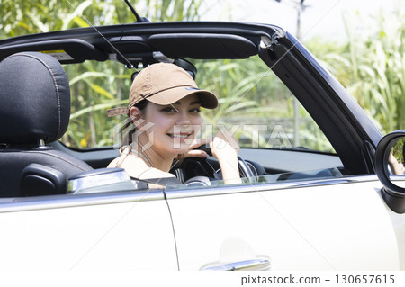 A young woman sightseeing in Okinawa by car 130657615