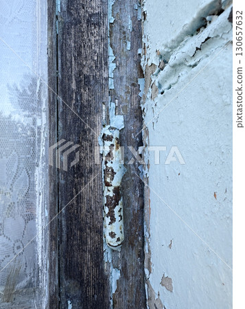 Fragment of an old wooden window frame. Peeling paint, lichen. Close-up. Fragment of an old wooden window frame. Peeling paint, lichen. Close-up. 130657632