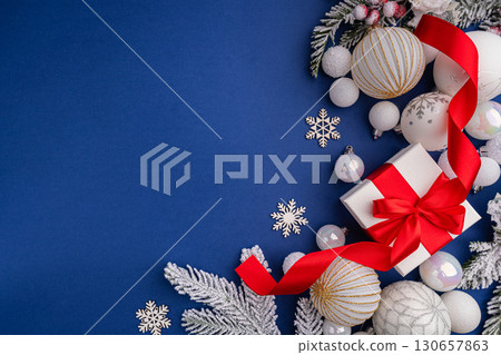White Christmas Gift with Red Ribbon and Ornaments on Blue 130657863