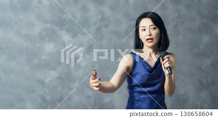 Female singer singing with a microphone 130658604