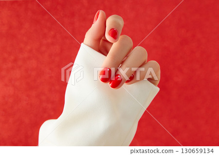 Close up womans hand with red minimalist nail design. Manicure, pedicure beauty salon concept Close up womans hand with red minimalist nail design. Manicure, pedicure beauty salon concept 130659134