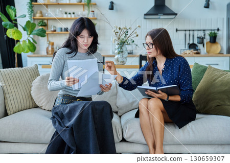 Female social worker working at home with young woman Female social worker working at home with young woman 130659307