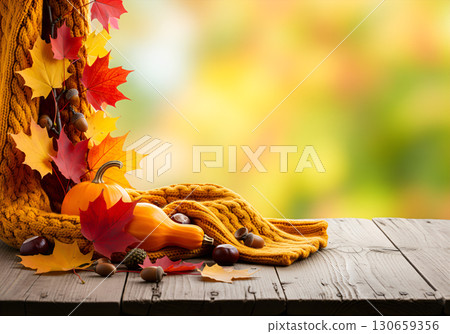 Atmospheric autumn composition with pumpkins and leaves on a wooden background with space for text. 130659356