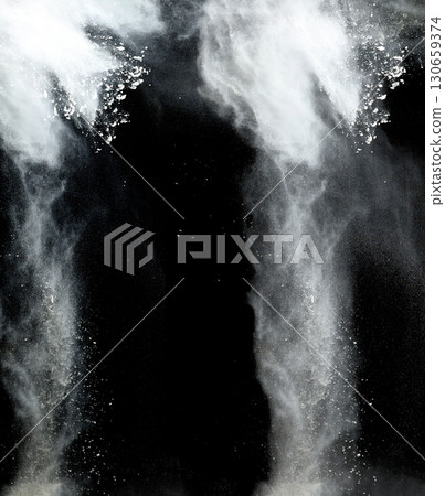 Clouds of white flour or powder scattering against a black background, creating the effect of dynamic movement Clouds of white flour or powder scattering against a black background, creating the effect of dynamic movement 130659374