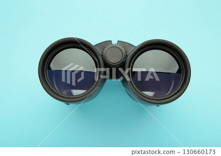 Binoculars on blue background. Top view. 130660173