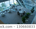Modern Indoor Space Featuring Contemporary Furniture, Lush Plants, and Large Windows, Creating an Inviting and Open Atmosphere for Relaxation and Collaboration 130660833