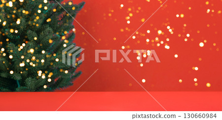Christmas red background with green tree and golden glitter confetti and sparkles of lights blur bokeh. Christmas and New Year design holiday card Christmas red background with green tree and golden glitter confetti and sparkles of lights blur bokeh. Christmas and New Year design holiday card 130660984