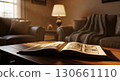 Open book on a cozy table with warm light. 130661110