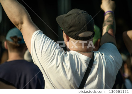 Person with Raised Arms at Open-Air Music Festival Person with Raised Arms at Open-Air Music Festival 130661121