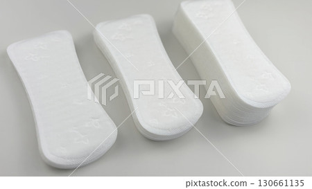 Womens sanitary pads on white background, top view. Feminine hygiene and menstruation product. Daily pad for period care, womens health, advertising, article or banner concept Womens sanitary pads on white background, top view. Feminine hygiene and menstruation product. Daily pad for period care, womens health, advertising, article or banner concept 130661135