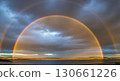 Bright rainbow stretches over evening horizon. 130661226