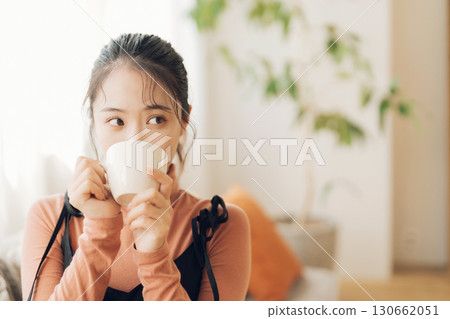 A woman drinking hot coffee 130662051