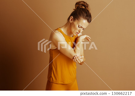Woman with Elbow Injury and Pained Expression 130662217