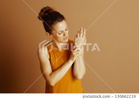 Woman with Pained Expression and Wrist Pain 130662219