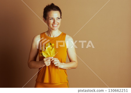 Cheerful Woman Holding Autumn Leaves 130662251