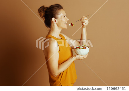 Health-Conscious Woman Enjoying Salad Health-Conscious Woman Enjoying Salad 130662461