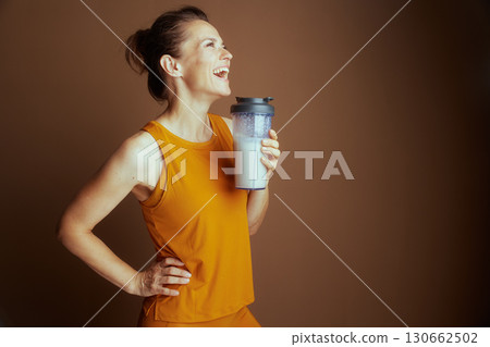 Smiling Woman in Yellow: Hydration Focus 130662502