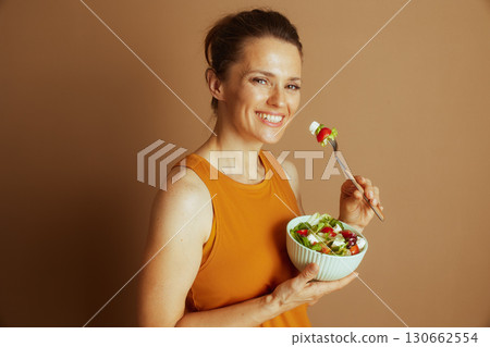 Smiling Woman with White Salad Bowl and Fork Smiling Woman with White Salad Bowl and Fork 130662554