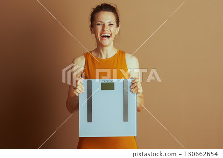 Joyful Woman Celebrating Weight Loss Success 130662654