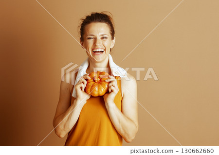 Joyful Autumn Fitness with a Playful Pumpkin 130662660