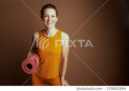 Confident Yoga Woman in Yellow and Orange Confident Yoga Woman in Yellow and Orange 130662664