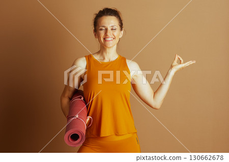 Serene Woman Meditating with Yoga Mat 130662678
