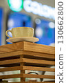 A cup of coffee on wooden decorative bar stand in coffee shop, close-up, vertical image, selective focus. 130662800
