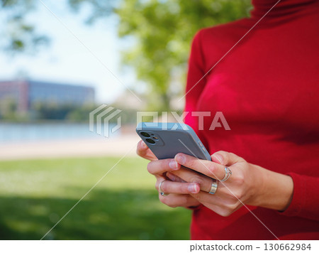 Woman in glasses stands in center of Frankfurt, 130662984